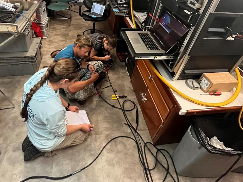 Remotely operated vehicle (ROV) crew working hard to troubleshoot a tracking issue with the ROV.