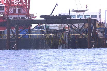 Engine being lifted to barge