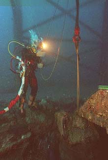 navy diver walking across Monitor's hull