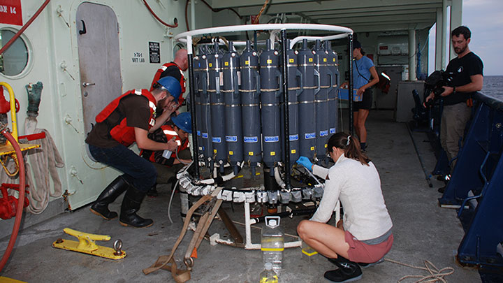 In this image, the DEEP SEARCH team immediately gets to work taking water fractions after the CTD rosette was hauled back onto the deck.