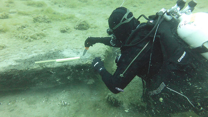 One important find made already as part of the expedition was an extensive deposit of preserved peat along the Alpena-Amberley Ridge. In this image, diver Tyler Schultz collects a sample of the peat.