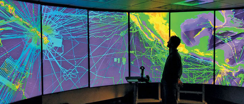 Person looking at large-scale bathymetry images. Image courtesy of the Inner Space Center