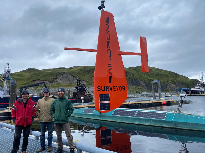 Saildrone field team members with the Saildrone Surveyor while in port in Dutch Harbor, Alaska.