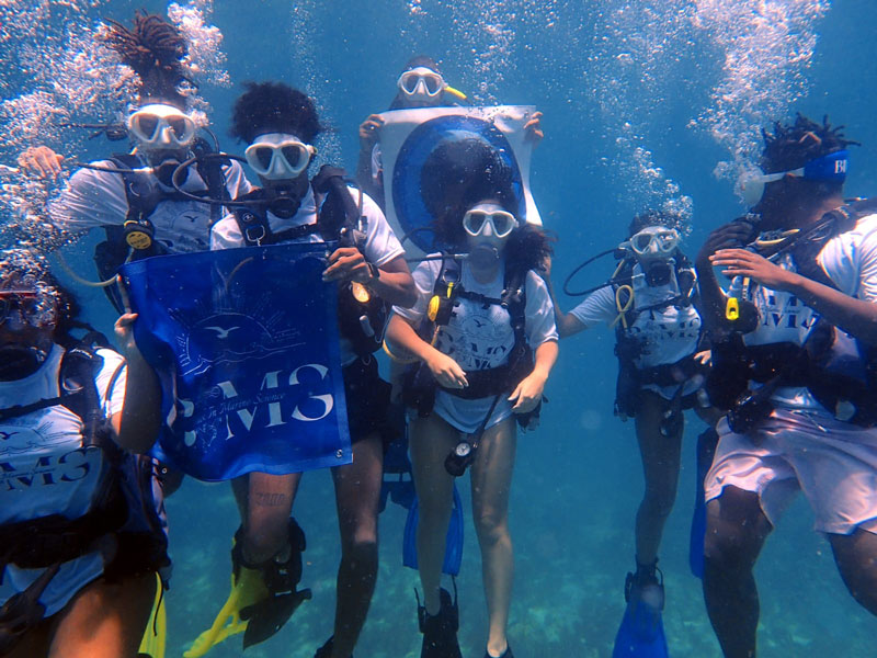 Newly-minted SCUBA divers show their Black in Marine Science pride underwater.
