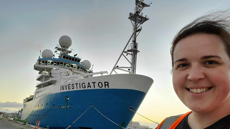Amanda Finn in front of the Commonwealth Scientific and Industrial Research Organisation (CSIRO)’s Research Vessel Investigator prior to the start of her 11-day transit voyage.