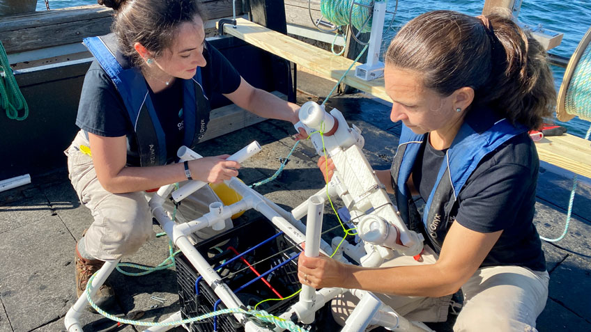 Ocean Discovery League Director of Engineering Dr. Jessica Sandoval (left) and ODL President and founder Dr. Katy Croff Bell (right) work on attaching a low-cost camera system and light modules to a prototype weighted lander configuration made of PVC pipe during deployment and recovery trials in the waters off Rhode Island. Accessible deployment and recovery systems are critical to the development of low-cost deep seas systems.