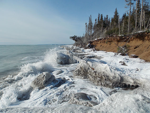 This photo was taken on February 2013 at Longue-Pointe-de-Mingan, on the north coast of the Gulf of St.Lawrence, Quebec, Canada. It show how the icefoot protects the sandy cliff face to the force of the waves during the winter season.