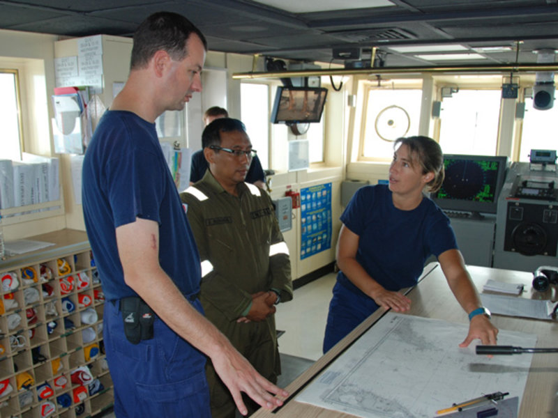 Commander Joe Pica and Lieutenant Nicky Verplanck discuss the ships position with TNI Official Major Adrianto, and confirm NOAA Ship Okeanos Explorer has entered the approved geographic bounds for INDEX SATAL 2010. Data acquisition commenced shortly afterwards.