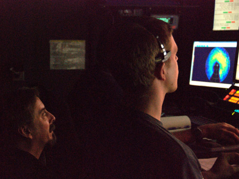 This image captures ROV Team member Tom Kok’s first stint in the ROV Pilot’s chair. Veteran Dave Wright sits behind him to provide guidance and advice as needed.