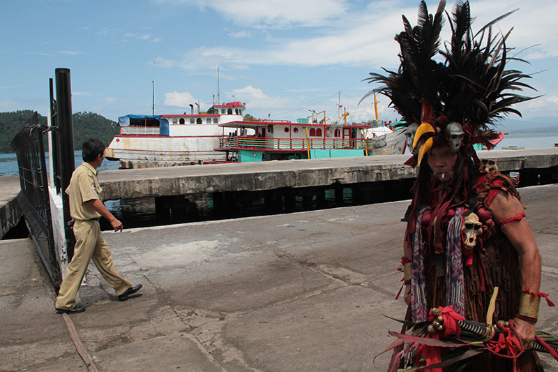 A traditional dancer walks along the dock during the June 23, 2010 Welcoming Ceremony in Bitung, Indonesia.