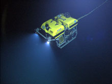 The ROV Little Hercules descends through deep-water down to Kawio Barat – an undersea volcano in the Celebes Sea 1900 to 5500 meters deep – to search for hydrothermal vents and associated ecosystems. Video collected by a high definition camera on Little Hercules and the camera platform are sent to the ship, to satellites in space, and to Exploration Command Centers on shore in real-time.