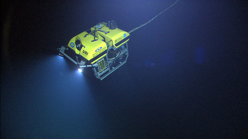 The ROV Little Hercules descends through deep-water down to Kawio Barat – an undersea volcano in the Celebes Sea 1900 to 5500 meters deep – to search for hydrothermal vents and associated ecosystems. Video collected by a high definition camera on Little Hercules and the camera platform are sent to the ship, to satellites in space, and to Exploration Command Centers on shore in real-time.