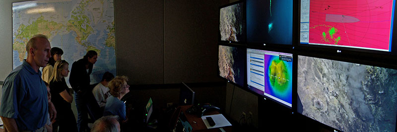Scientists and spectators located at the Seattle Exploration Command Center watch as a thriving hydrothermal ecosystem unfolds before them in video footage streamed live from the seafloor.