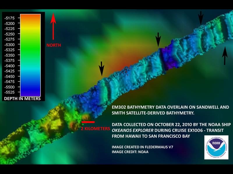The red 2 kilometer scale bar is placed near a feature that rises approximately 280 meters from the surrounding seafloor. The crater in the center of the cone-like structure indicates this feature might be volcanic.