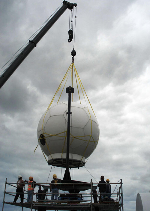 Almost 15-months ago, the ship mast was lowered to reduce stress on the VSAT. This April 2010 photo shows the VSAT being lowered onto the shortened mast.