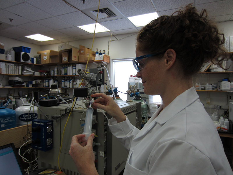 Jill McDermott, PhD student at Woods Hole Oceanographic Institution, uses the gas chromatograph to determine the hydrogen and methane content of a water sample in the Seewald lab.