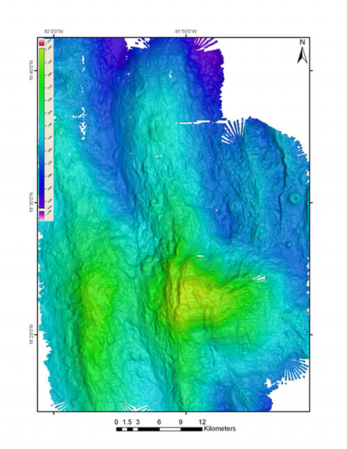 Figure 2:  Backscatter (left) and multibeam (right) 50m grids of the same area around Mount Dent collected by the EM302.  These two images, although generated from the same data file, provide very different information about the same area of the seafloor.