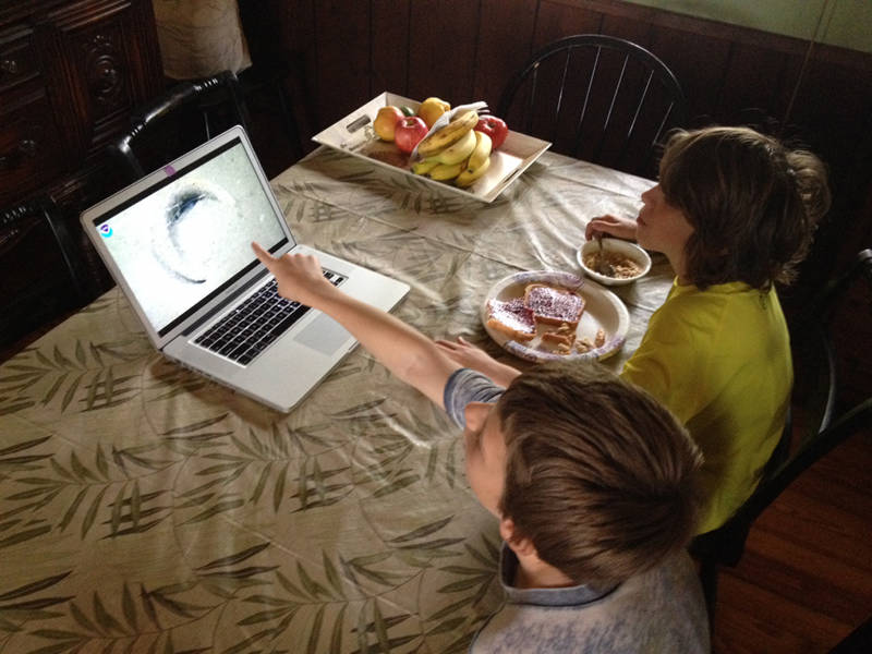 Thanks to telepresence technology, anyone with Internet could follow the exploration. Here, Oliver and Edwin Tartt watch the mission over breakfast while their family is on vacation in South Carolina.