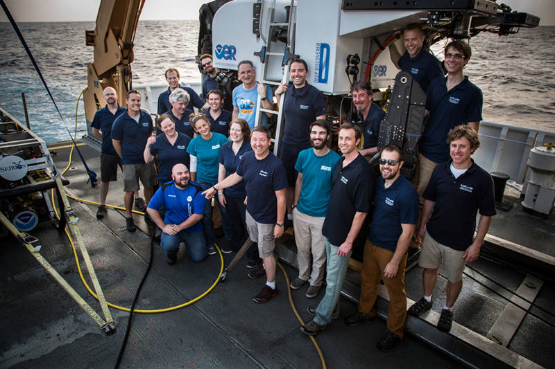 The on-ship exploration team poses with D2 at the end of the expedition.