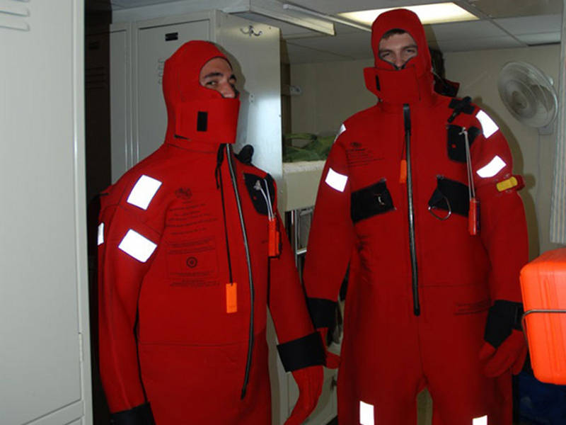 During an abandon ship drill, new mission personnel were required to don immersion suits, or as we call them, Gumby suits. Here LT Kevin Micheal and David Rivera demonstrate the proper way to wear the suit, hood on and flap closed over your face.