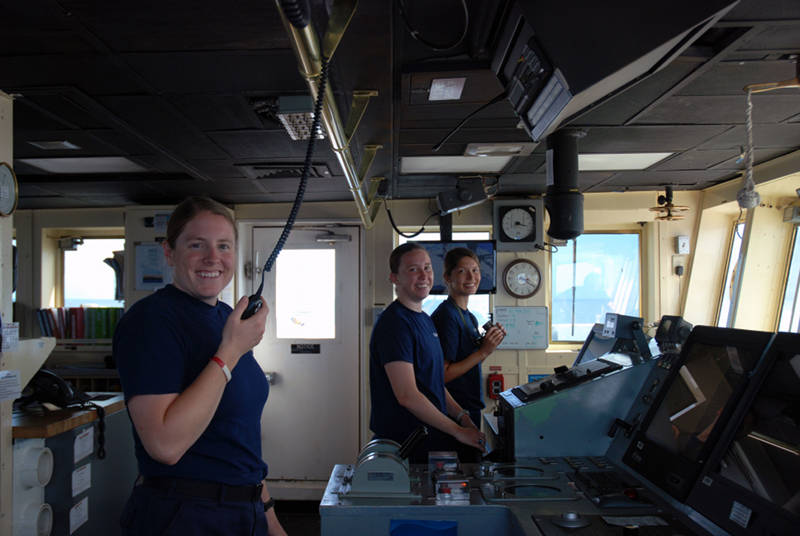 To effectively explore the oceans, we need a good crew to safely navigate and drive the ship. Here’s three of our female crew members taking control at the helm. From left to right are NOAA Corps Officer LT Emily Rose, USCG Cadet Megan Toomey, and USCG Cadet Shelia Dutt. Megan and Shelia are between the junior and senior years at the Coast Guard Academy, they joined the ship for this expedition to gain hands on experience driving a large ocean-going vessel.