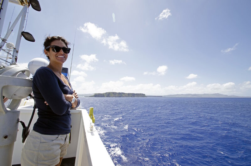 Leg 1 Biology Science Team Lead, Dr. Diva Amon, enjoying the view as NOAA Ship <em>Okeanos Explorer</em> heads to sea to start tthe expedition.