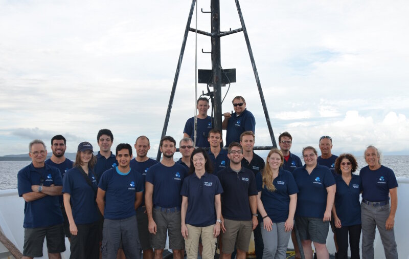 The shipboard mission team poses on the bow of the ship as Leg 3 comes to a close.