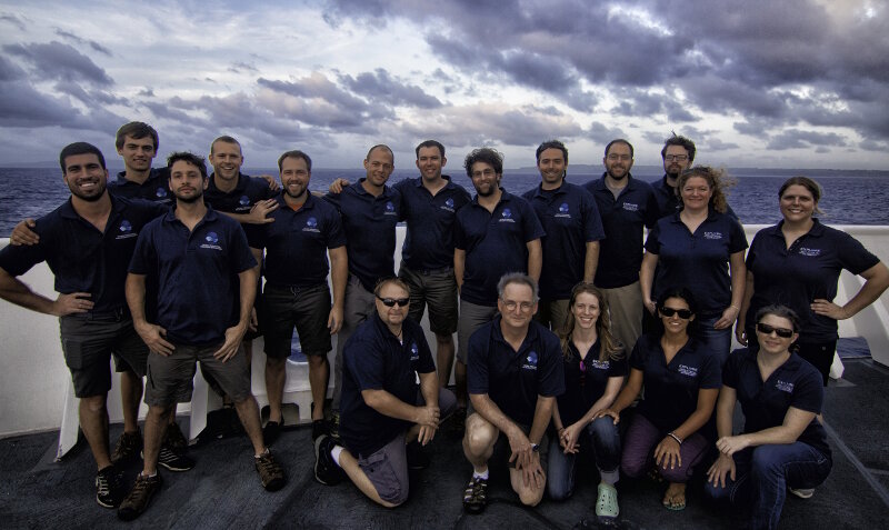 The Shipboard Mission Team poses for a picture on the bow of the ship before pulling into port in Saipan to bring Leg 1 of the expedition to a close.