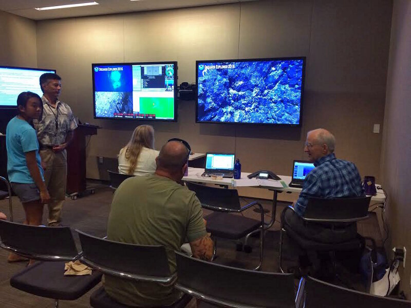 A group tunes into the live feeds from the IRC ECC and participates in the expedition from shore.