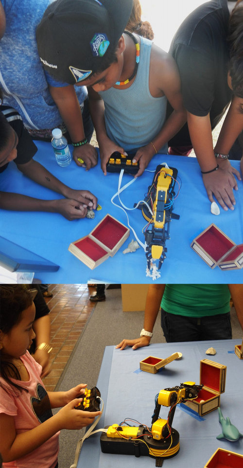 Students loved using a toy robotic arm to pick up samples and put them into boxes.