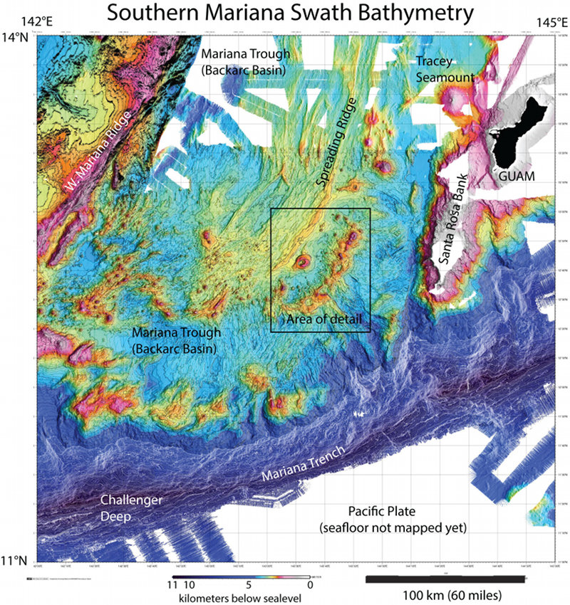 Bathymetry of the southern Mariana region. Colors show water depths: dark blue is deepest, reds are shallowest, black is land, and white shows areas that have not been mapped yet. This map required data from many cruises to compile (compilation thanks to Susan Merle, NOAA Pacific Marine Environmental Laboratory, Newport, Oregon). Box shows area of detail shown in Fig. 2.