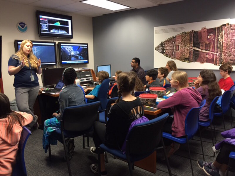 OER's Kasey Cantwell addresses a group of students at an Exploration Command Center.