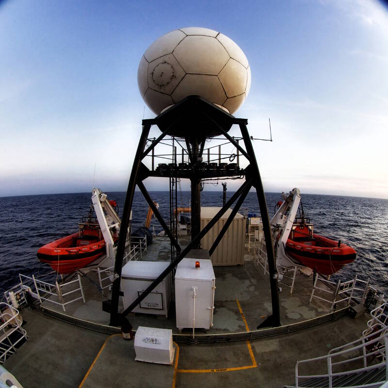 The VSAT (large dome; stands for “Very Small Aperture Terminal”) is the critical piece of infrastructure that makes telepresence possible.