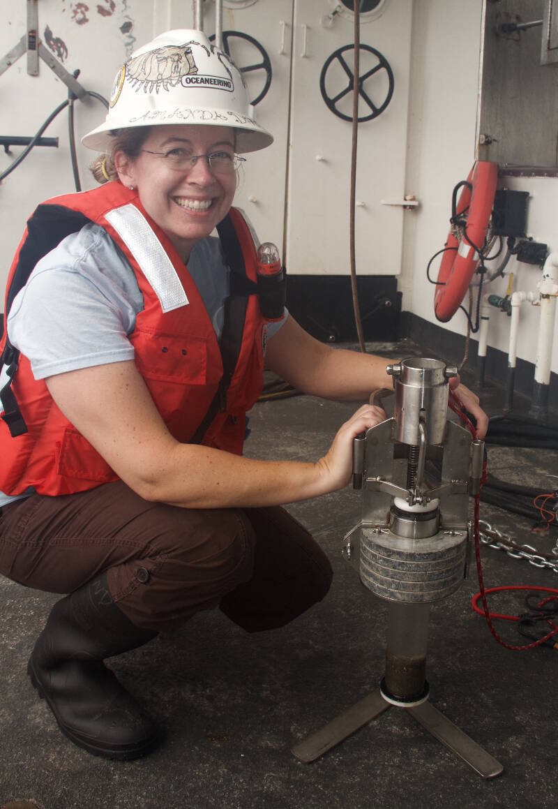 Co-host of “Deep-sea TV,” Dr. Amanda Demopoulos, holds a monocore, an instrument used to collect a discrete sample of the bottom sediments.