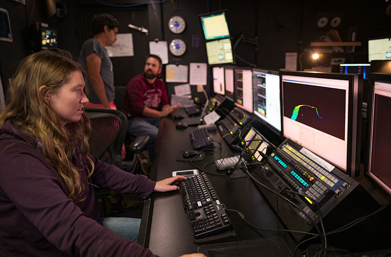Mapping Watchstander, Neah Baechler, edits recently acquired multibeam data in the control room on NOAA Ship Okeanos Explorer.
