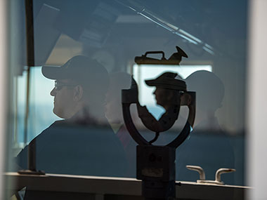 Crewmembers of NOAA Ship Okeanos Explorer on the bridge as the ship departs Pascagoula, Mississippi. 