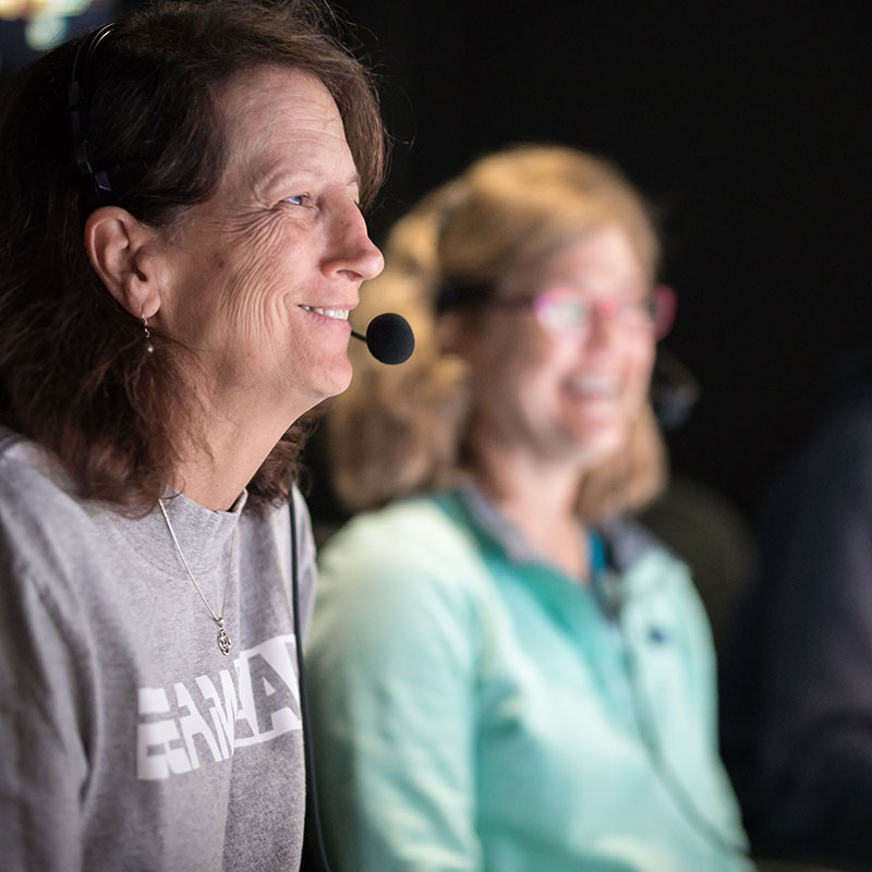 Expedition co-science lead and geologist, Leslie Sautter, in the control room on NOAA Ship Okeanos Explorer narrating one of the dives during the Windows to the Deep 2018 expedition.