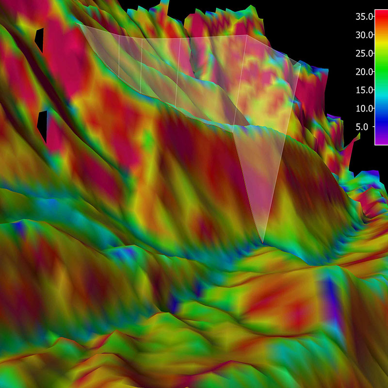 Three-dimensional view of the planned ROV track for Dive 15, shown as an orange line. The background represents the seafloor depth color-coded with slope in degrees; the warmer the color, the steeper the slope.