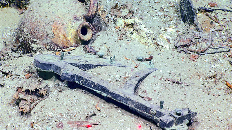 An octant discovered during an expedition dive on the Blake Ridge Wreck, which was originally discovered by a team from Duke University in 2015 and is likely an early 19th century wreck. Indicative artifacts imaged during the dive included an octant, bottles of wine, ceramic jugs, containers for food and other liquids, a small sewing kit with a pile of brass buttons, a slate, a vase, a tobacco pipe, and a comb. Data collected during the dive was used by the Bureau of Ocean Energy Management to develop a 3D photogrammetry model of the wreck.