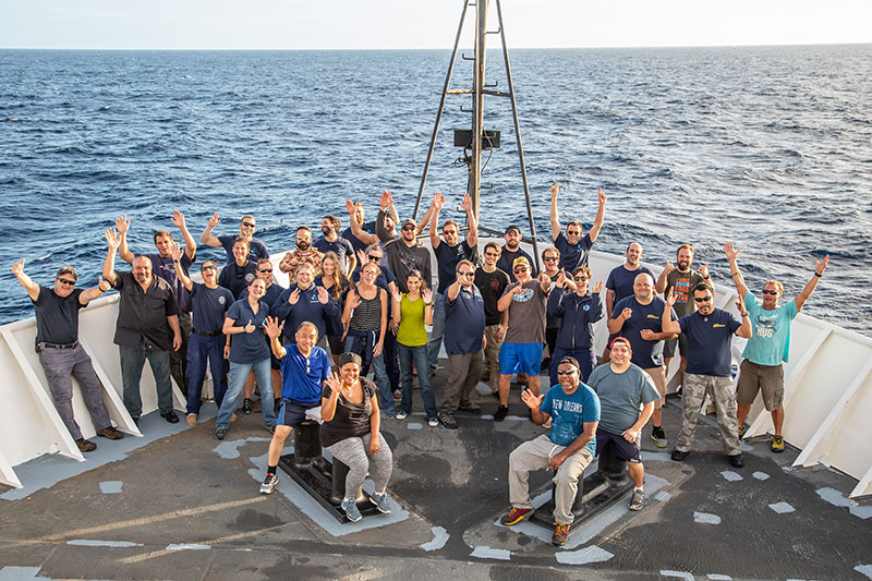 The on-ship expedition team gathers for a group photo on the deck of NOAA Ship Okeanos Explorer.