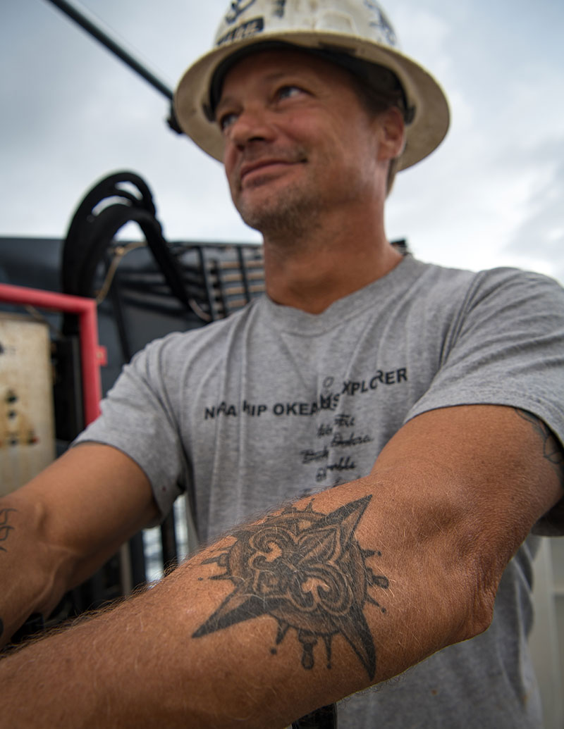 Jerrod is fond of the compass rose that he has tattooed on his left arm, which he got five years ago in New Orleans. It is a common nautical tattoo as the compass rose is used to find your location on a chart and determining your direction. The fleur de lis in its center is Jerrod’s personal touch signifying his faith.