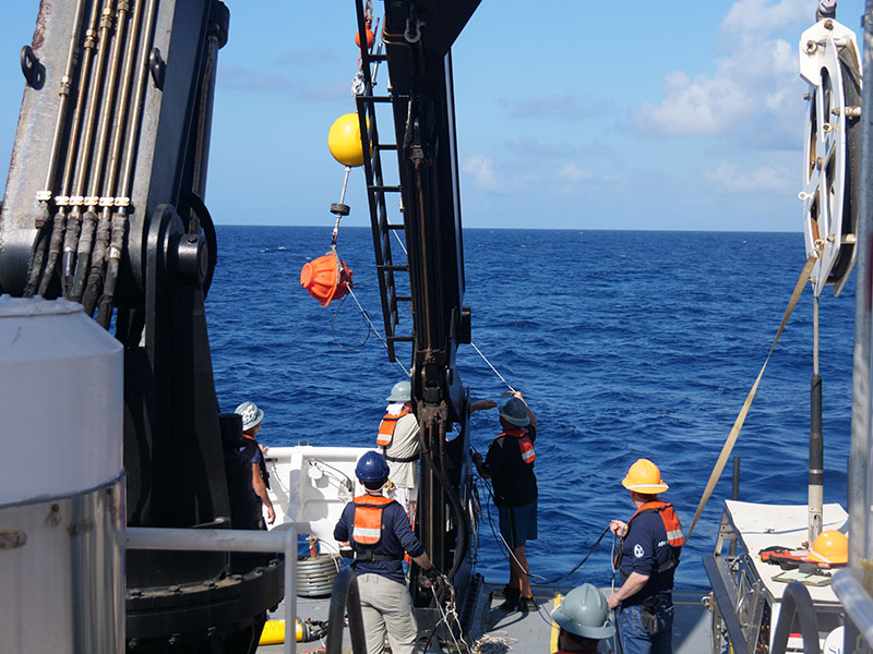 Deploying the hydrophones that will be used to listen for multibeam pings in order to better understand where the multibeam transmits its sound. Image courtesy of Levi Unema, GFOE.