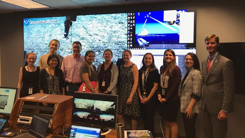 Herbert Leavitt (second from left, back row) in the NOAA Silver Spring Exploration Command Center (ECC), along with RDML Gallaudet and other NOAA staff, fellows, and interns.