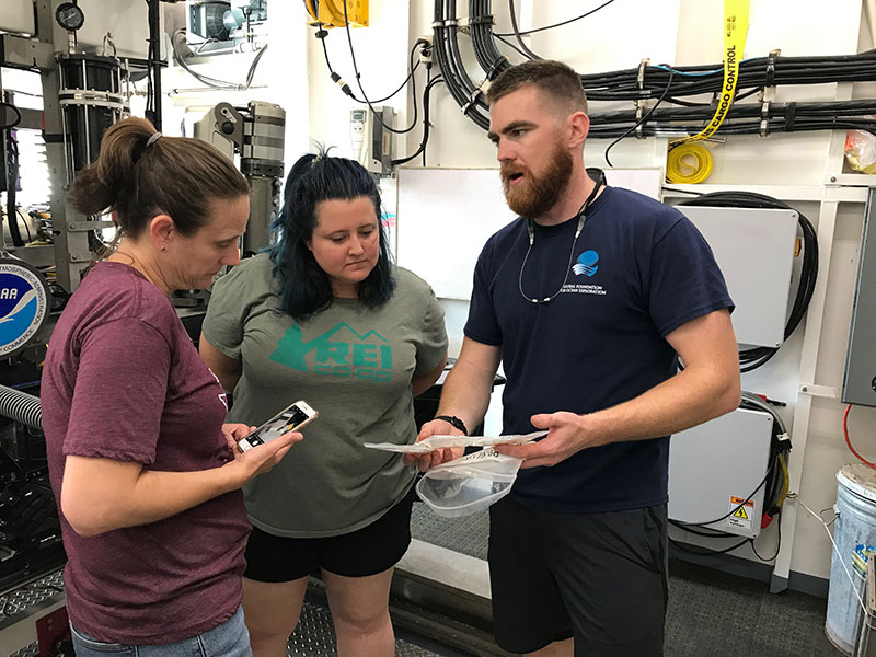 Lars Murphy discusses one of the new tools added to the remotely operated vehicle Deep Discoverer over the winter with Science Leads Alexis Weinnig and Amy Wagner as they discuss how to approach sampling operations during this expedition.