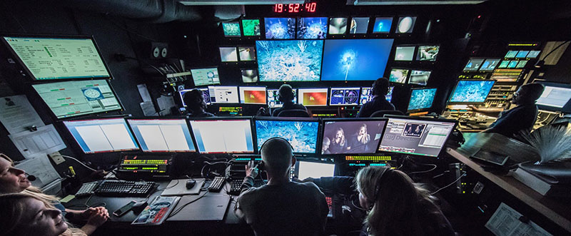 Science team inside the mission control room aboard NOAA Ship Okeanos Explorer during an ROV Dive.