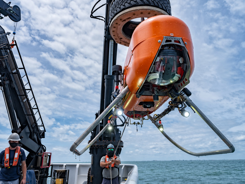 The autonomous underwater vehicle Orpheus being deployed from NOAA Ship Okeanos Explorer. This AUV’s compact shape, thrusters, mapping software, and camera allow for exploration of the hadal zone, or the deepest region of the ocean.