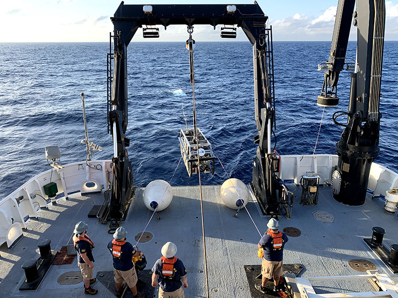 For the first dive of the season, remotely operated vehicle (ROV) Deep Discoverer bobs at the surface in the background while deck crew launch ROV Seirios so the pair can begin their descent to the deep sea.
