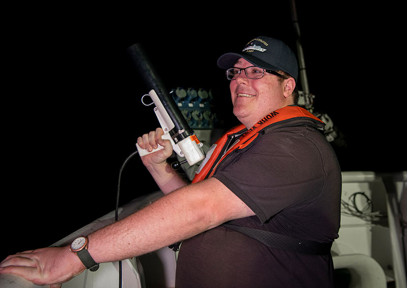 Explorer-in-Training Henry Arndt prepares to conduct an XBT (Expendable Bathythermograph) cast in order to correct mapping data for water column variability during the 2022 Caribbean Mapping expedition.
