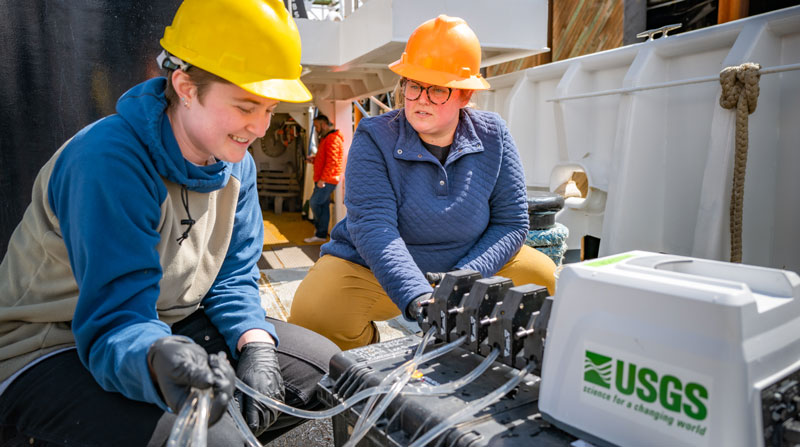 Expedition geology science lead Paige Koenig and expedition biology science lead Alexis Weinning set up the eDNA (environmental DNA) test kit associated with the water U.S. Geological Survey filtration system tested during the 2023 Shakedown + EXPRESS West Coast Exploration expedition.