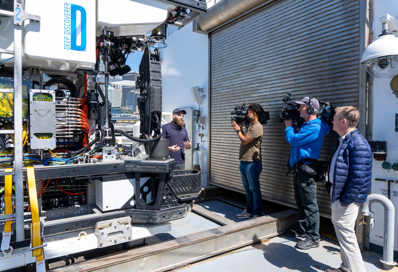 NOAA Ocean Exploration expedition coordinator Thomas Morrow discusses the capabilities of remotely operated vehicle Deep Discoverer with several members of the media who toured the ship after the end of the 2023 Shakedown + EXPRESS West Coast Exploration expedition.